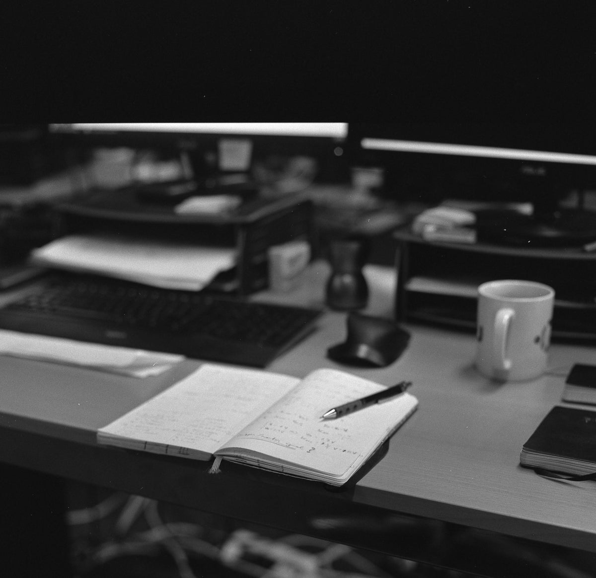 A desk at the end of the afternoon, nothing on it finished